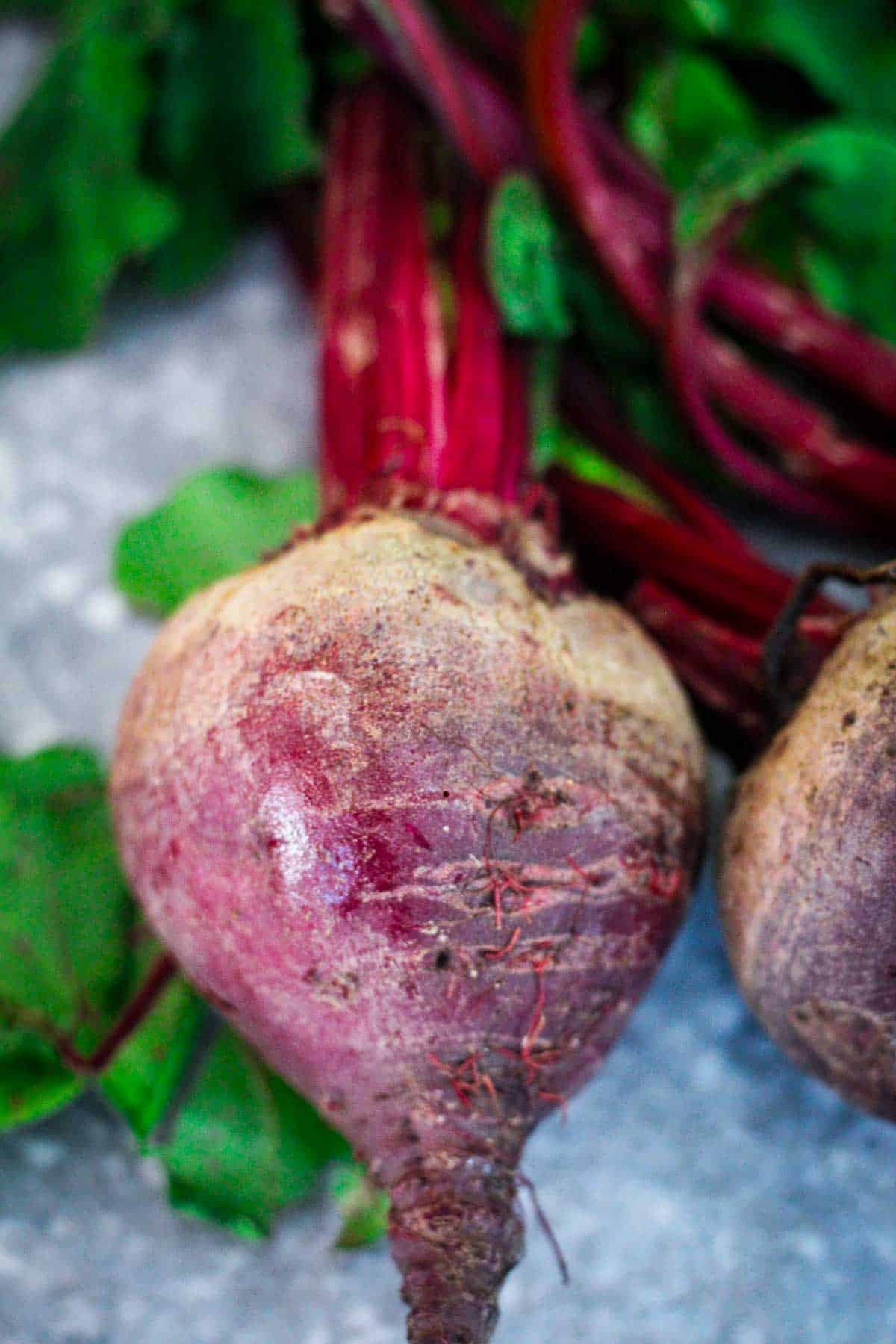 A raw beet, uncooked, un-peeled.