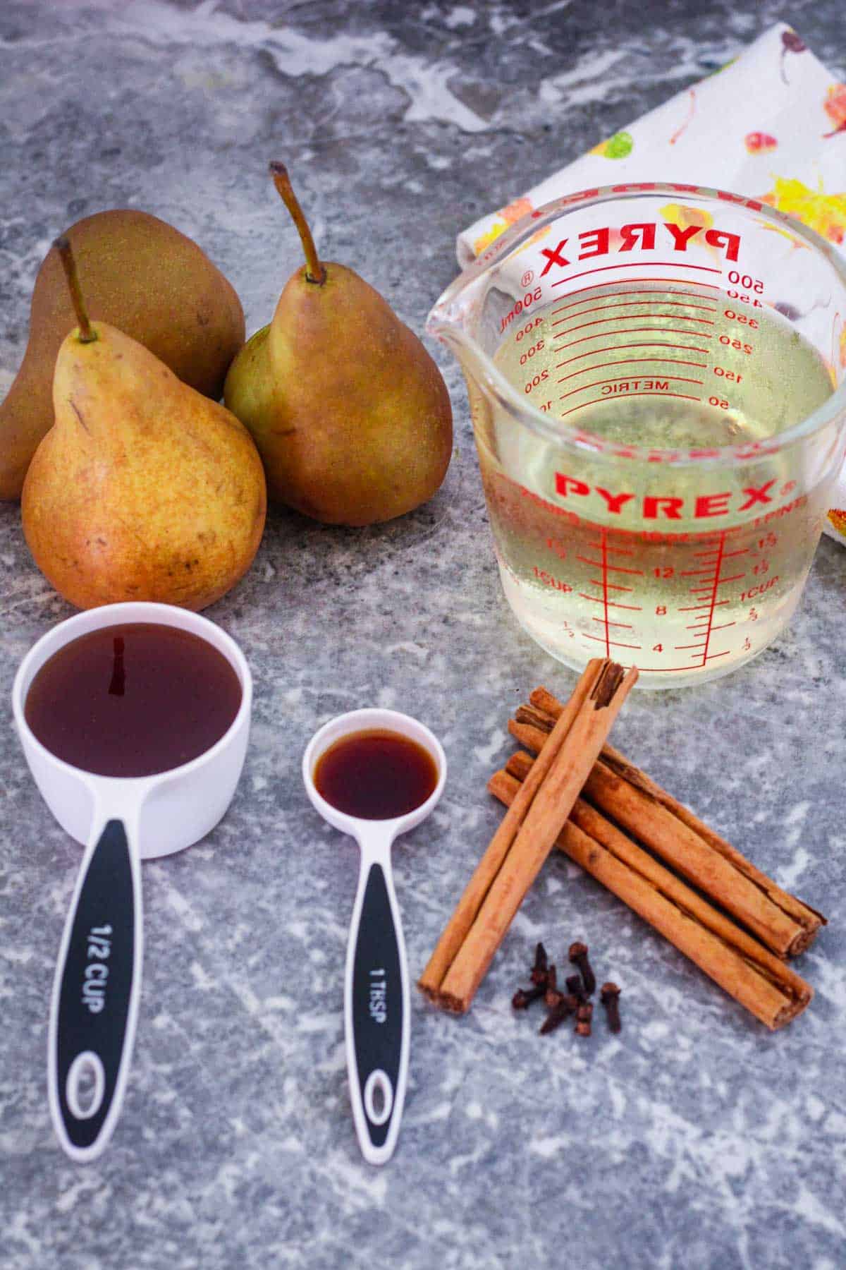 Ingredients to make poached pears with white wine and spices.