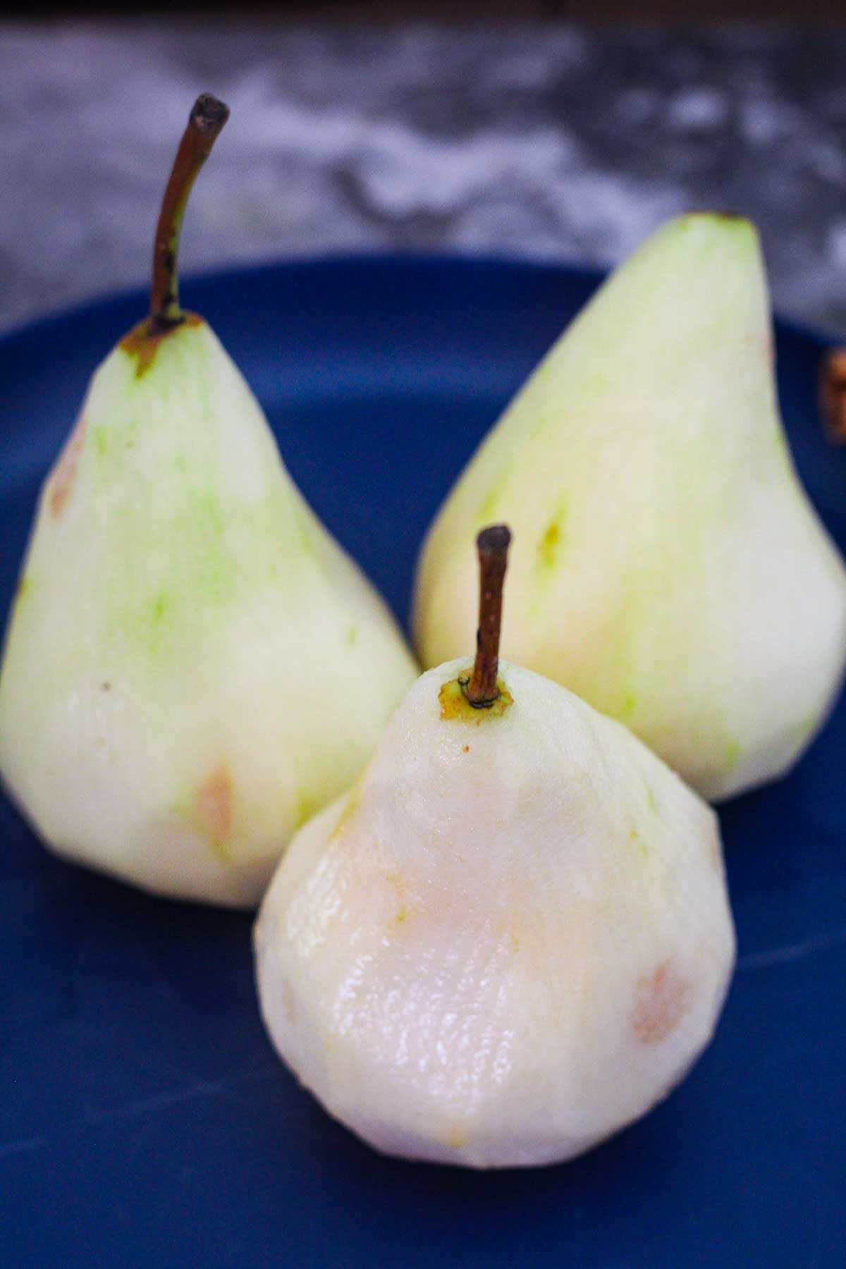 Peeled pears, ready to put in syrup to poach.