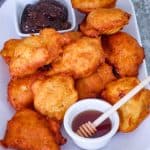 Albanian petulla (fried dough) shown served on a platter with fig jam, honey etc.