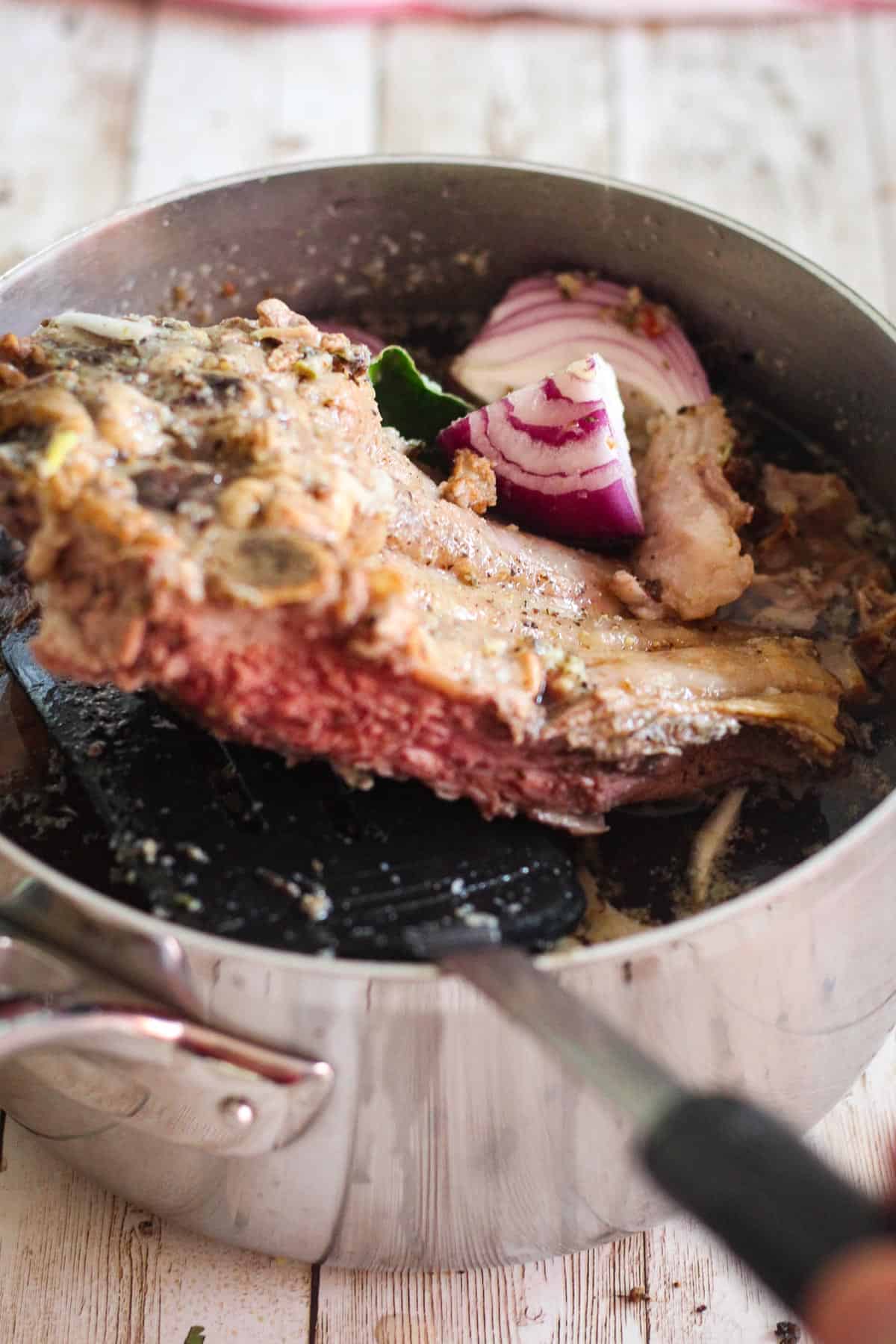 A pot with broth and leftover prim rib. 