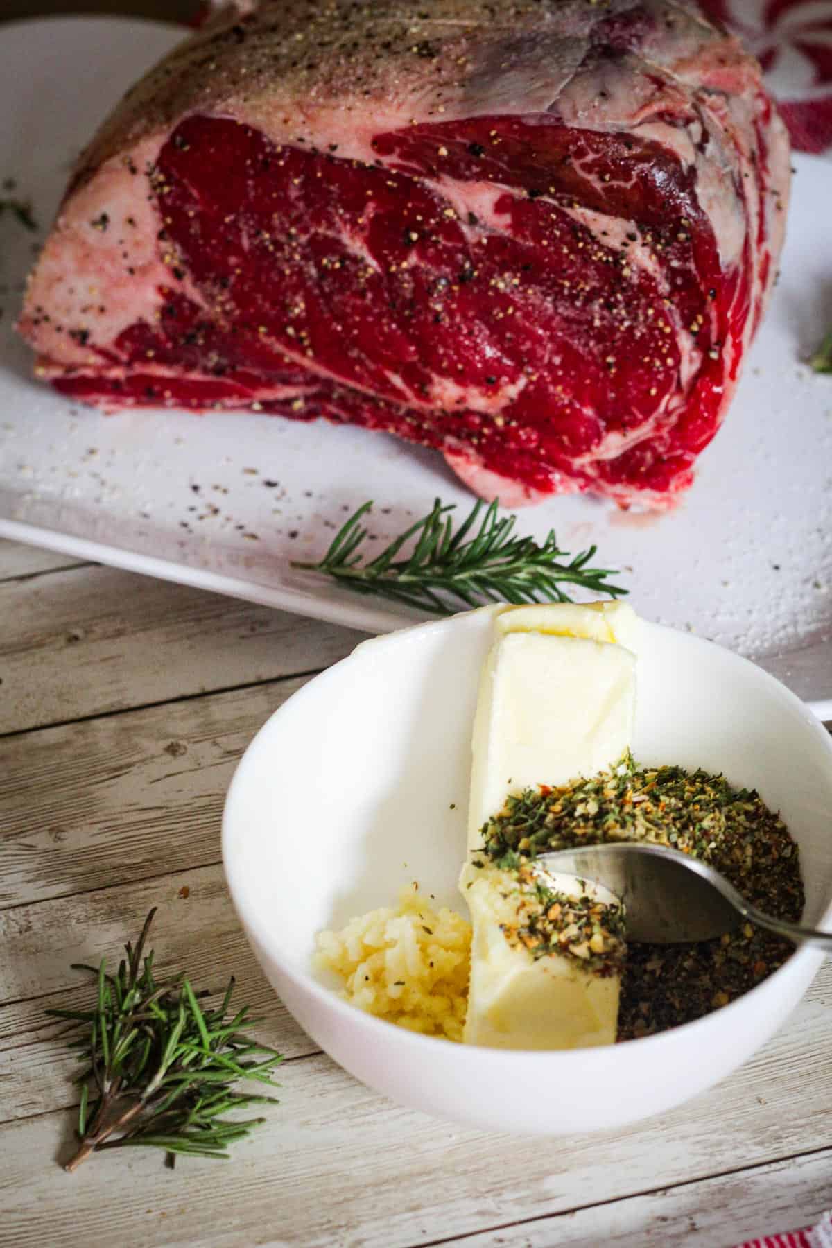 Making herbed butter with a stick of butter, mix of herbs and minced garlic right in front of the prime rib. 