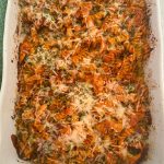 A casserole dish with chicken pasta bake, shown right out of the oven.