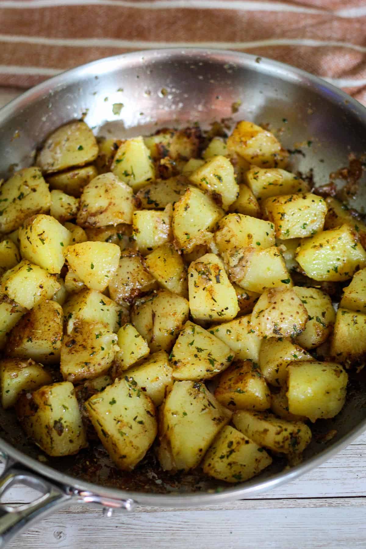 Cooking the potatoes in the skillet. 