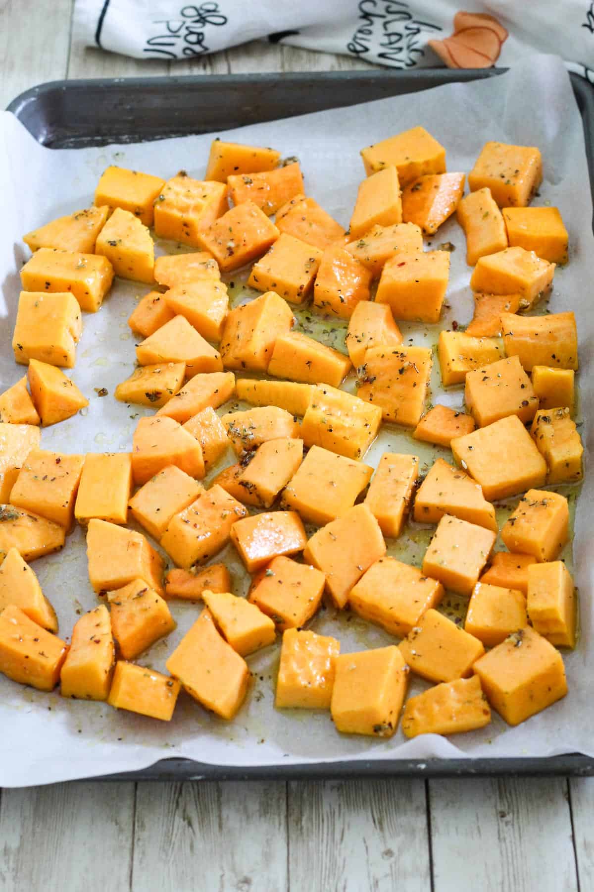 Butternut squash cubed, seasoned in the baking tray over parchment paper. 
