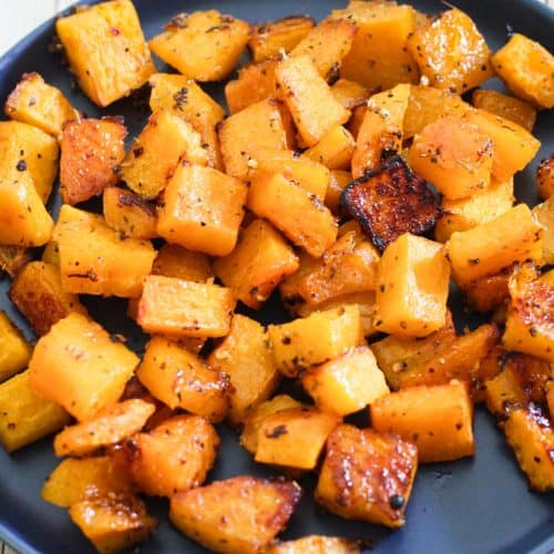 Roasted butternut squash shown in a blue round plate.