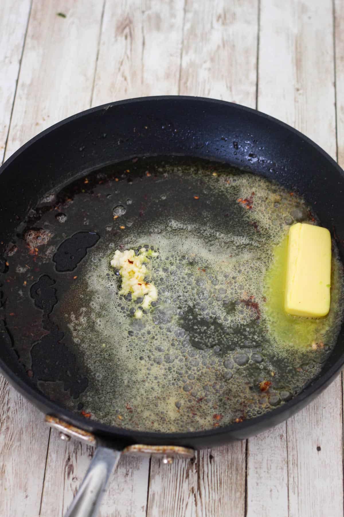 Once mahi mahi is removed from pan, add butter and minced garlic.